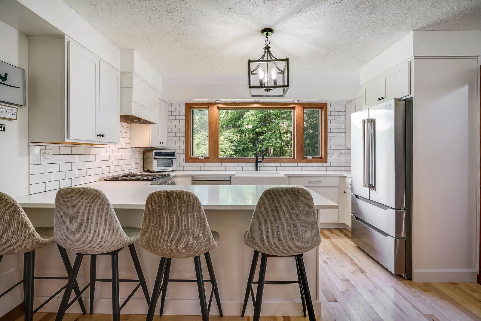 Diamond Vibe kitchen, white shaker cabinetry with island seating, Spofford NH, by Triumph