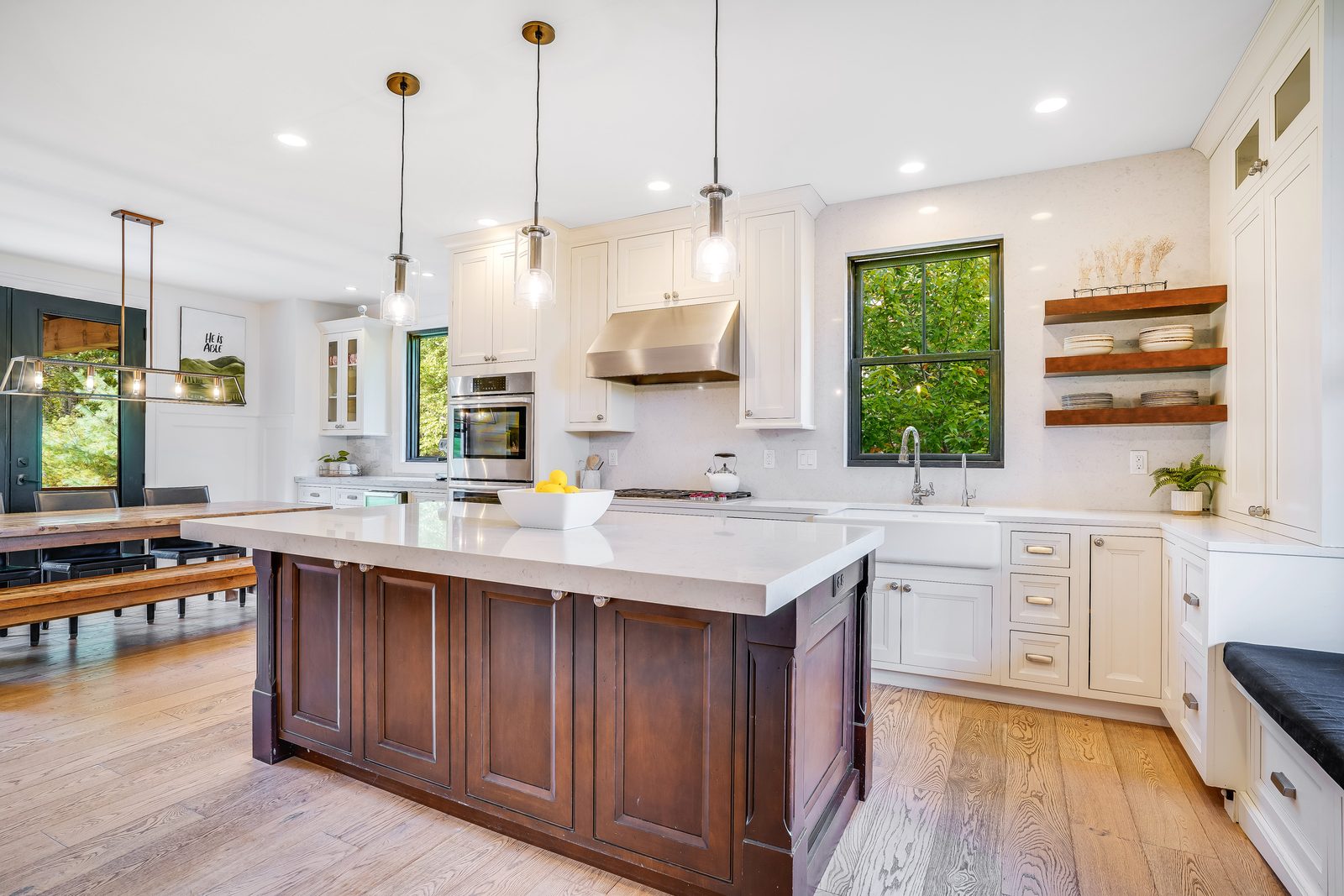 Sable-stained island with white quartz top and window bench beyond