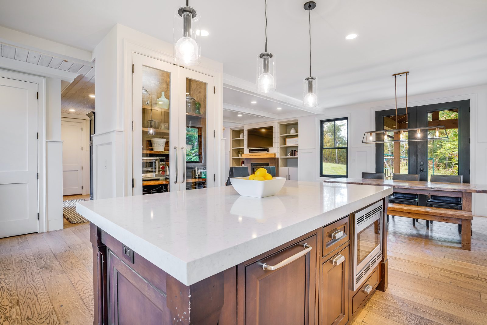 Island corner with glass-front pantry doors behind