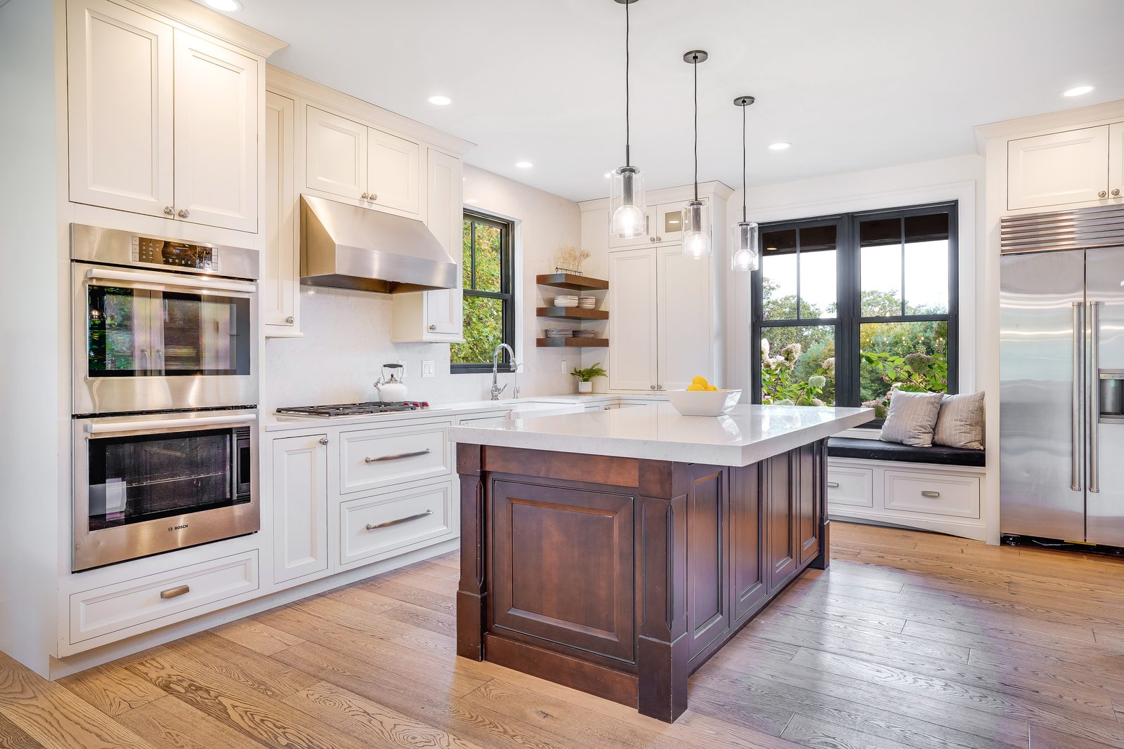 Double wall ovens, paneled fridge wall and window seat