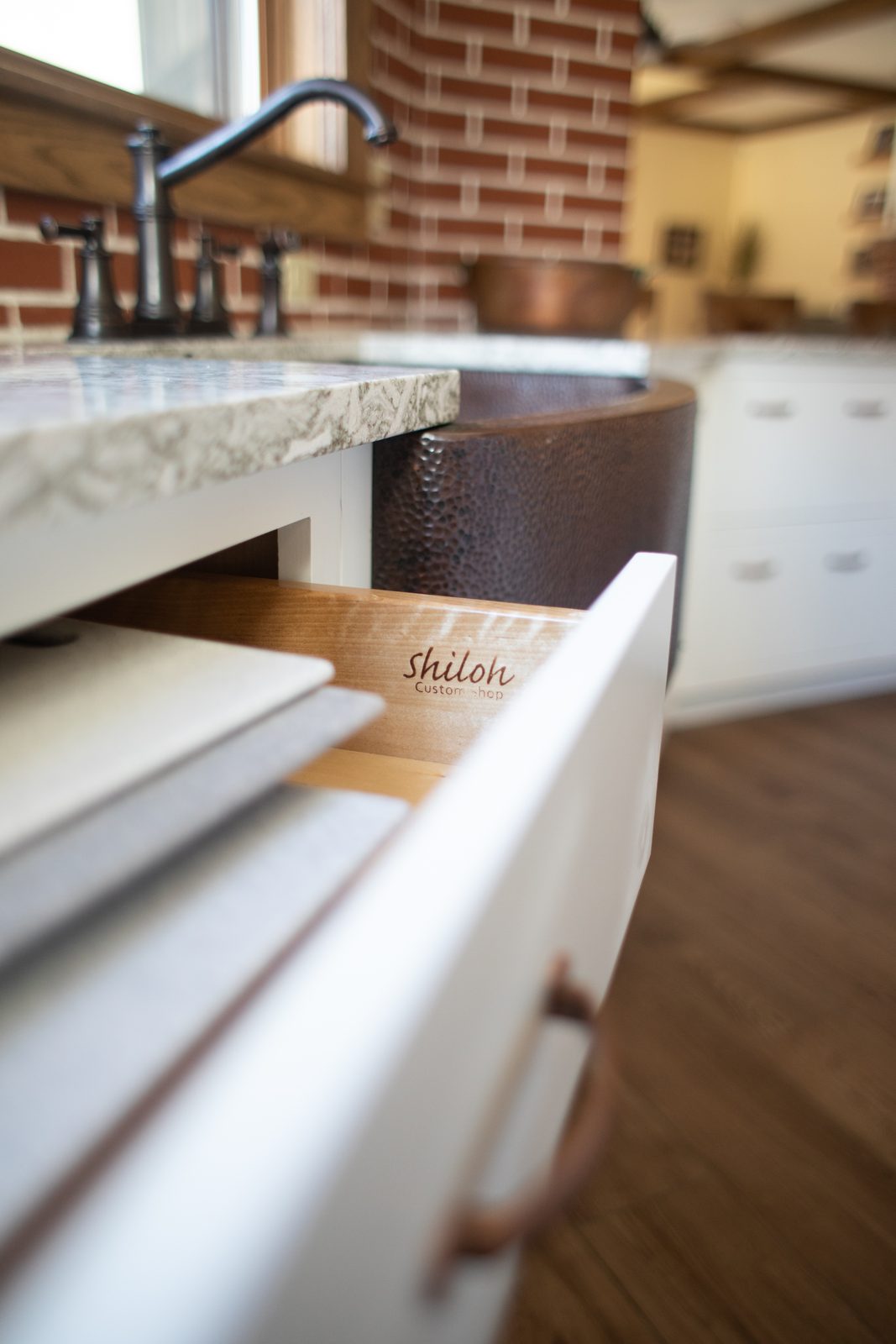 Dovetail drawer with the Shiloh stamp beside a farmhouse sink