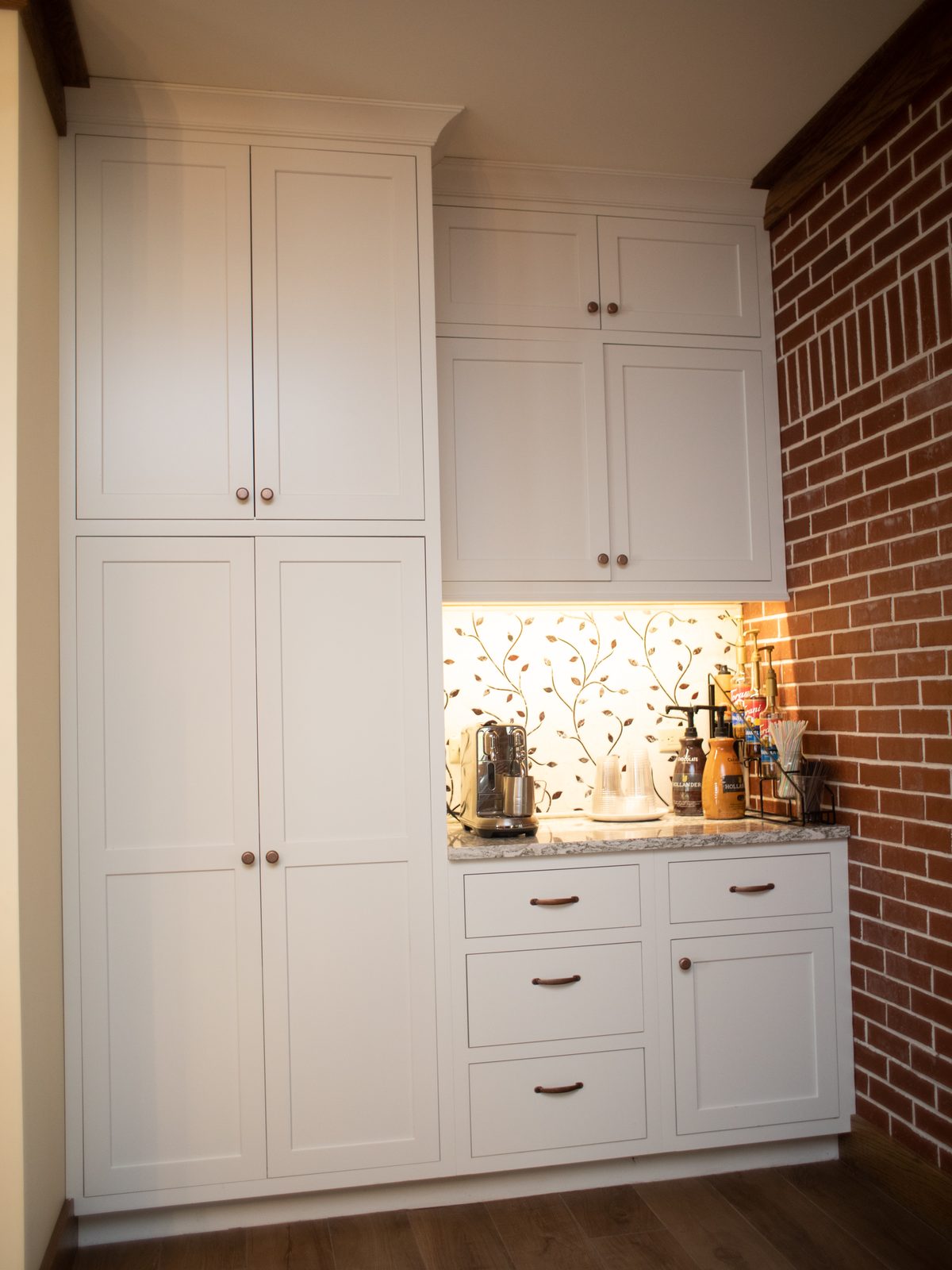 Coffee bar with tall pantry cabinets