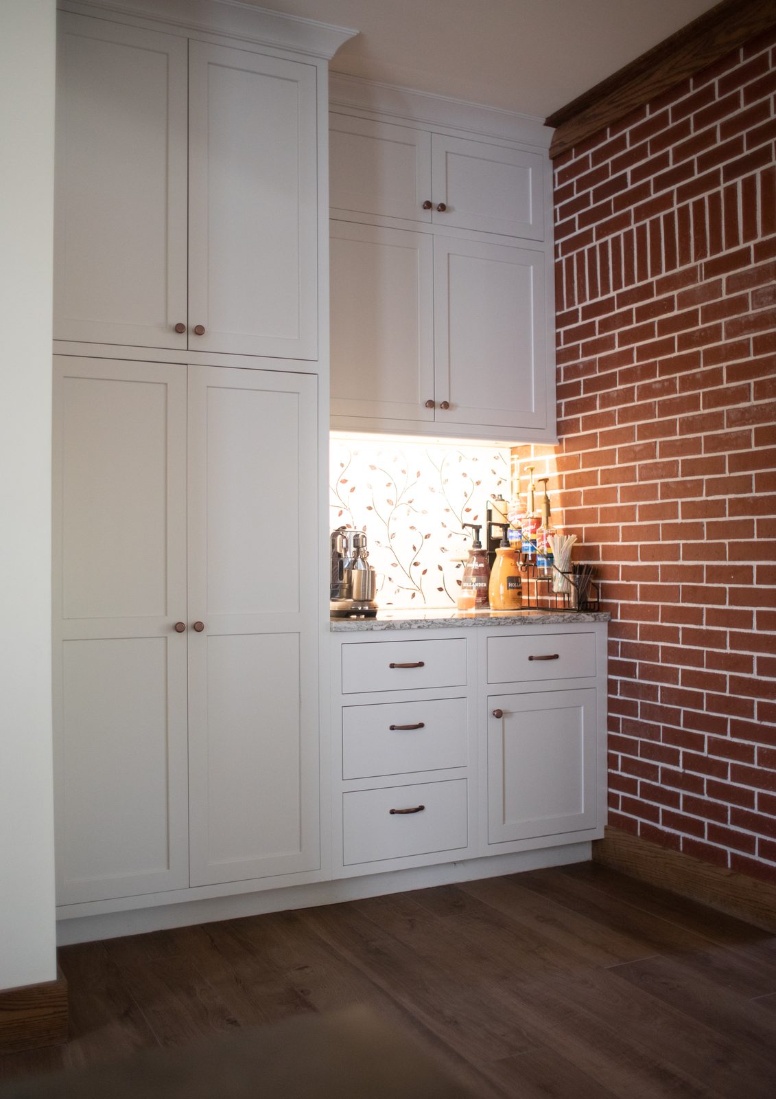 Base cabinet run against exposed brick