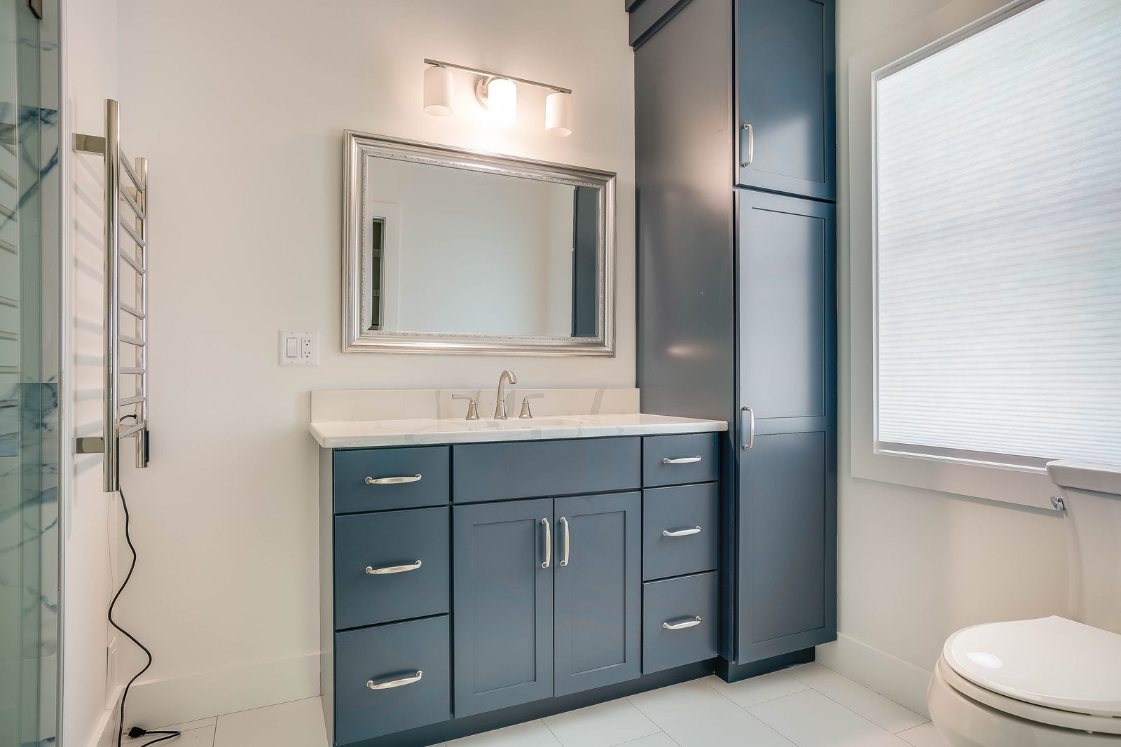 Maritime blue bathroom vanity with linen tower