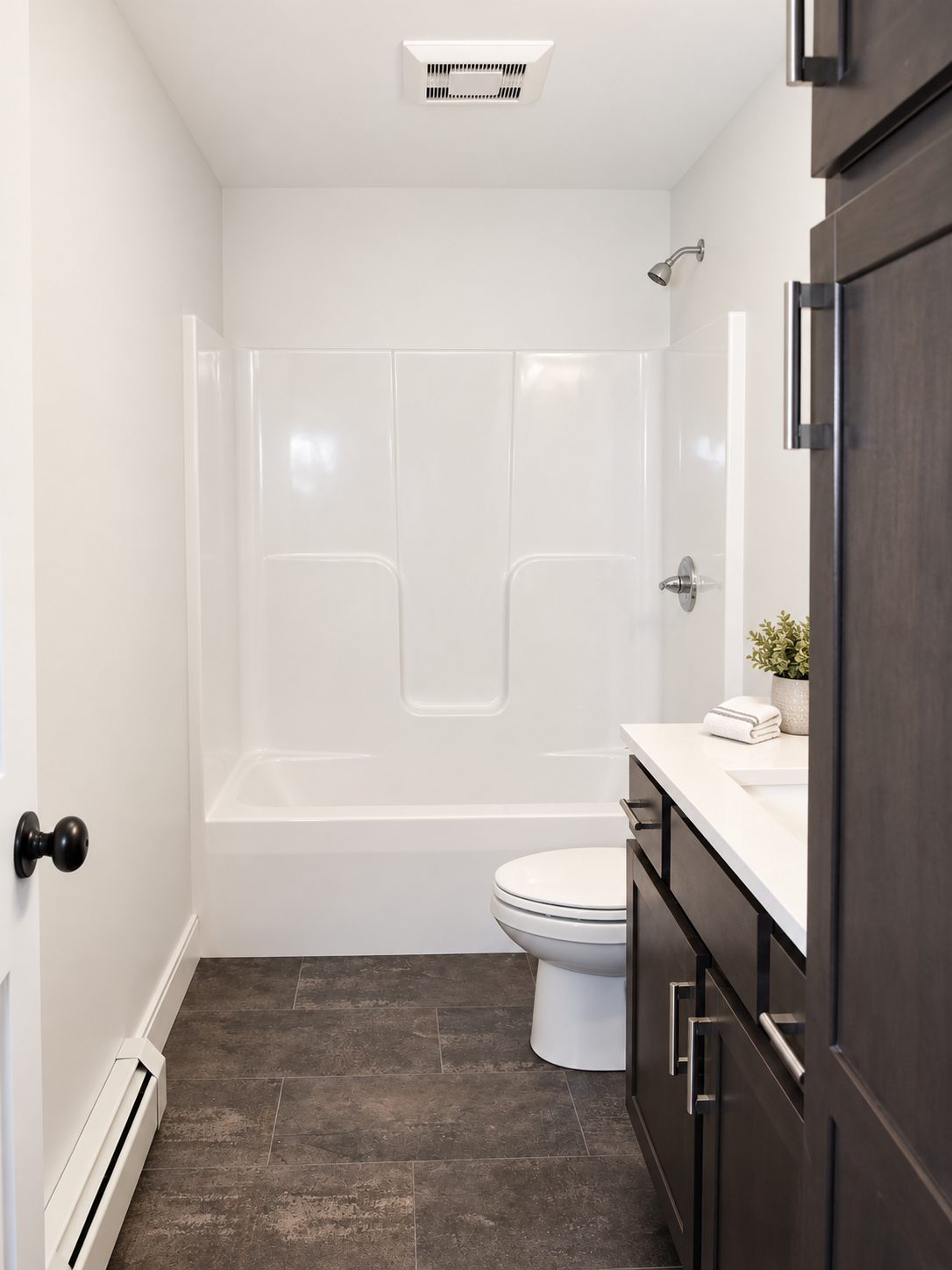 Bath with dark stained vanity and tub