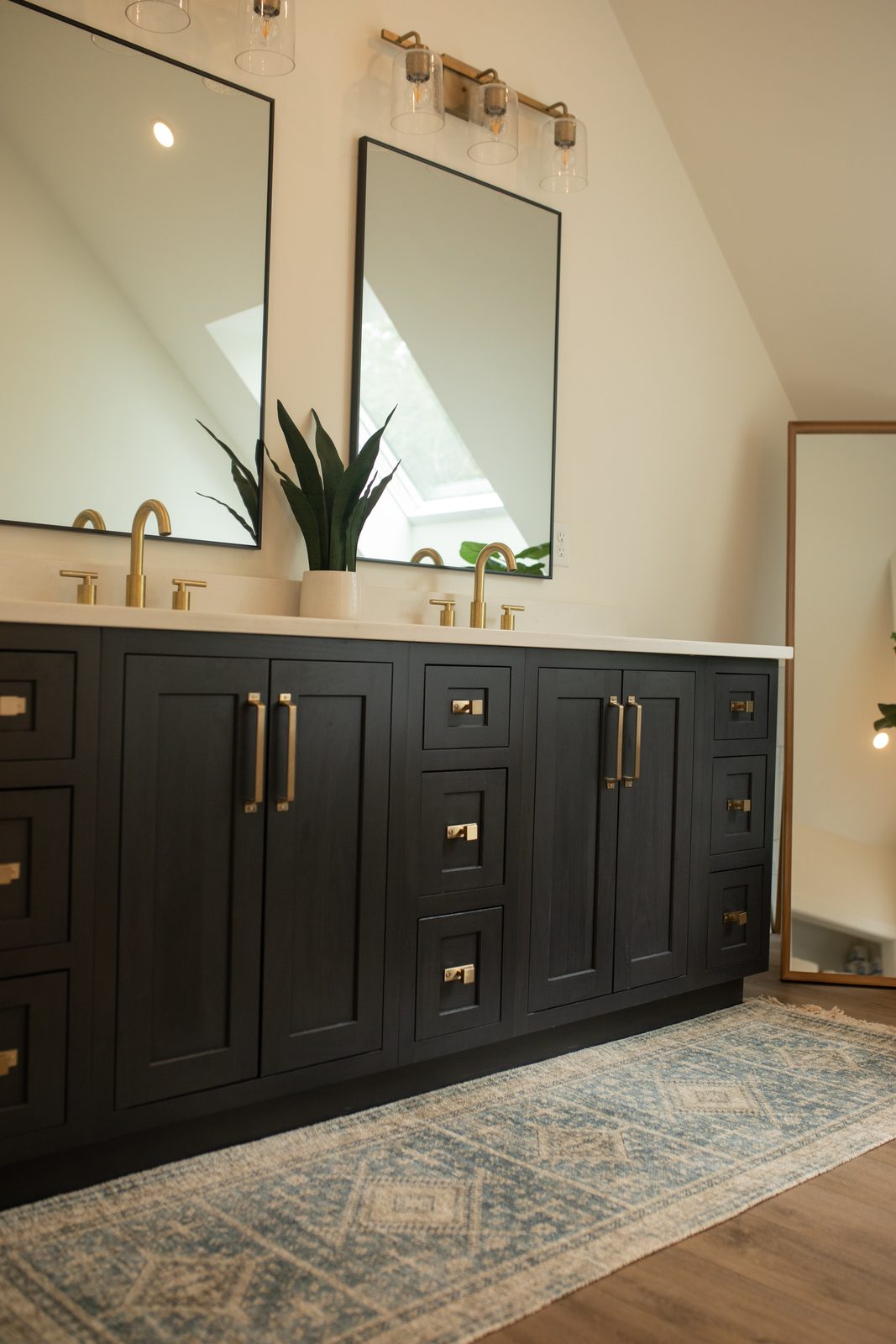 Black double vanity with brass hardware