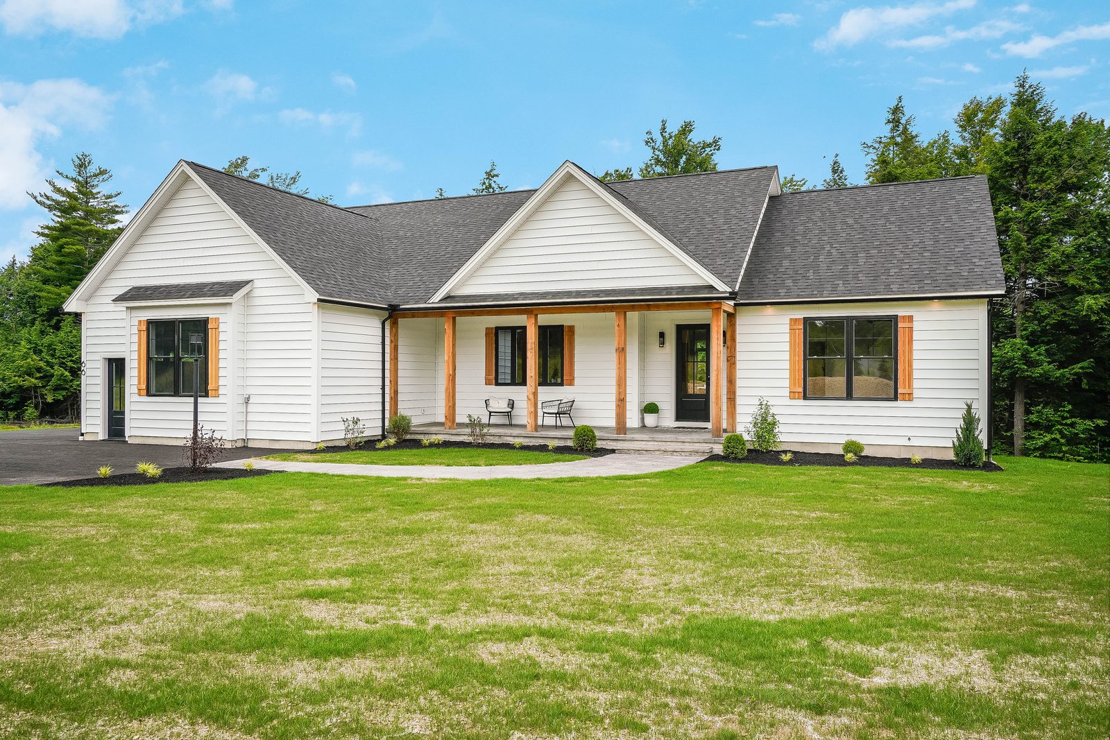 White farmhouse exterior with timber porch posts