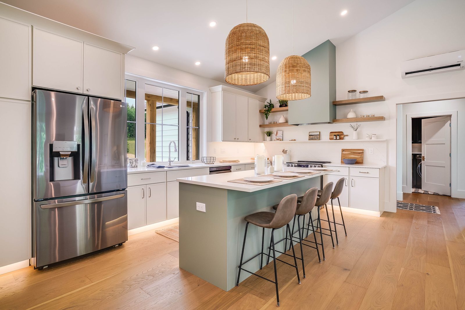 Kitchen angle with stainless fridge and undercabinet-lit island