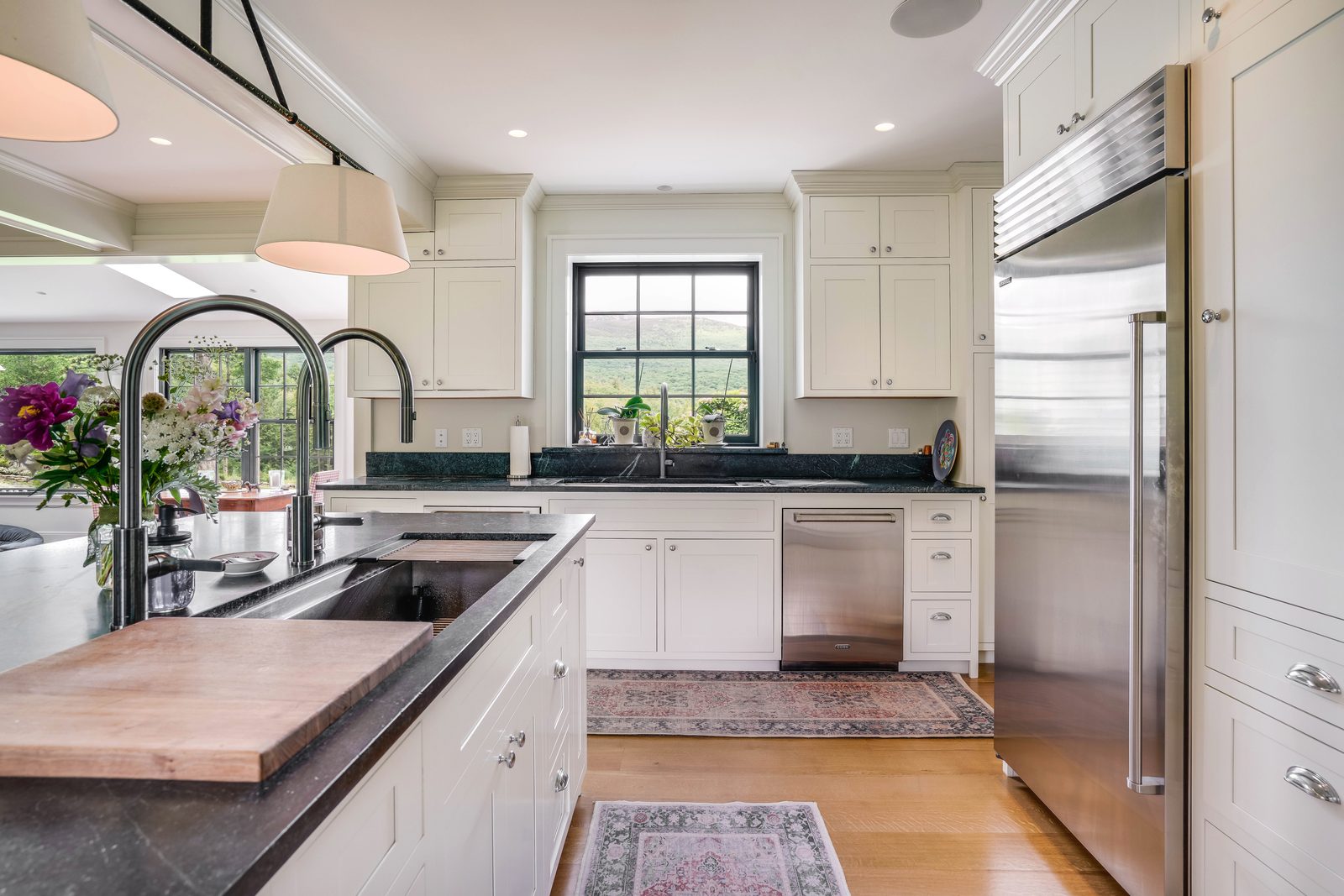 Prep sink and windows over dark stone counters