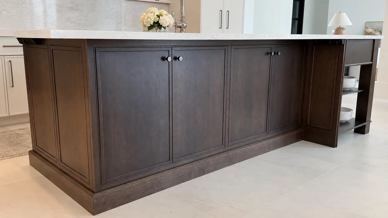 Dark rift oak beaded-inset island with marble top and gunmetal knobs