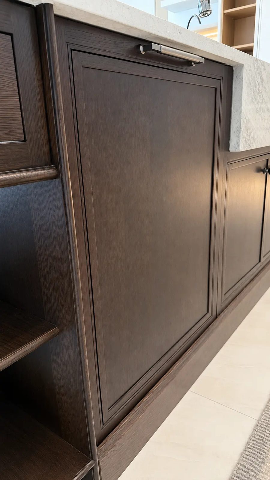 Beaded-inset end panel detail at the island dishwasher run