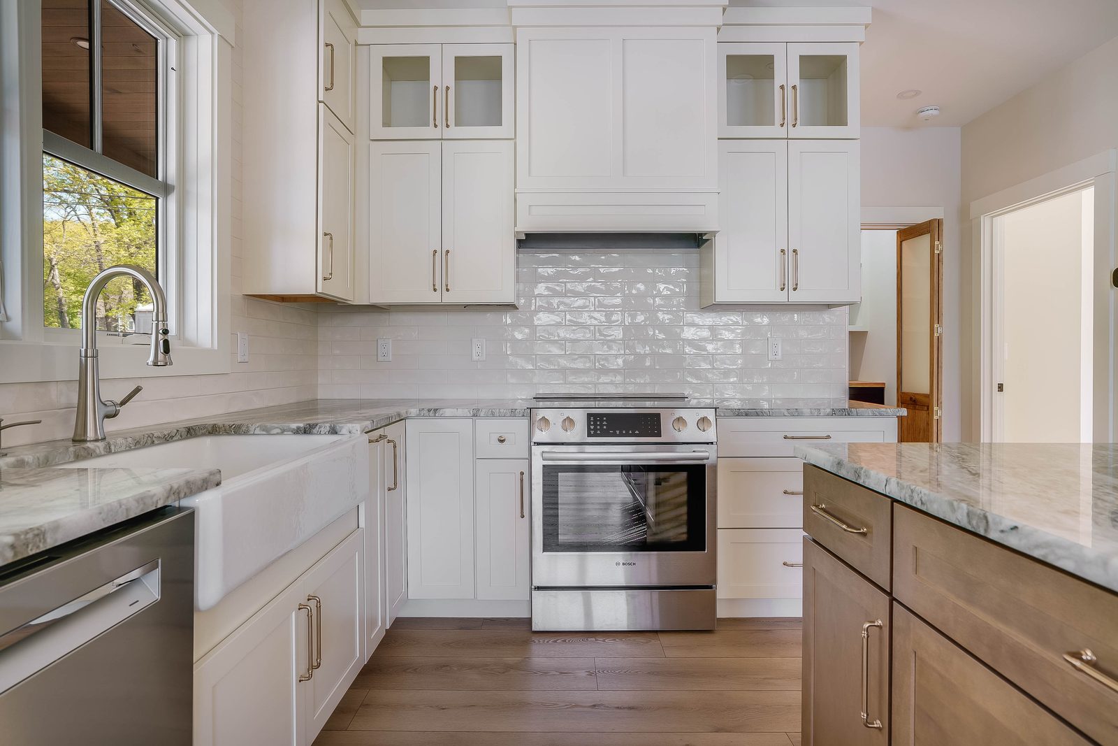 Range wall in Coconut white with brass hardware and glass uppers