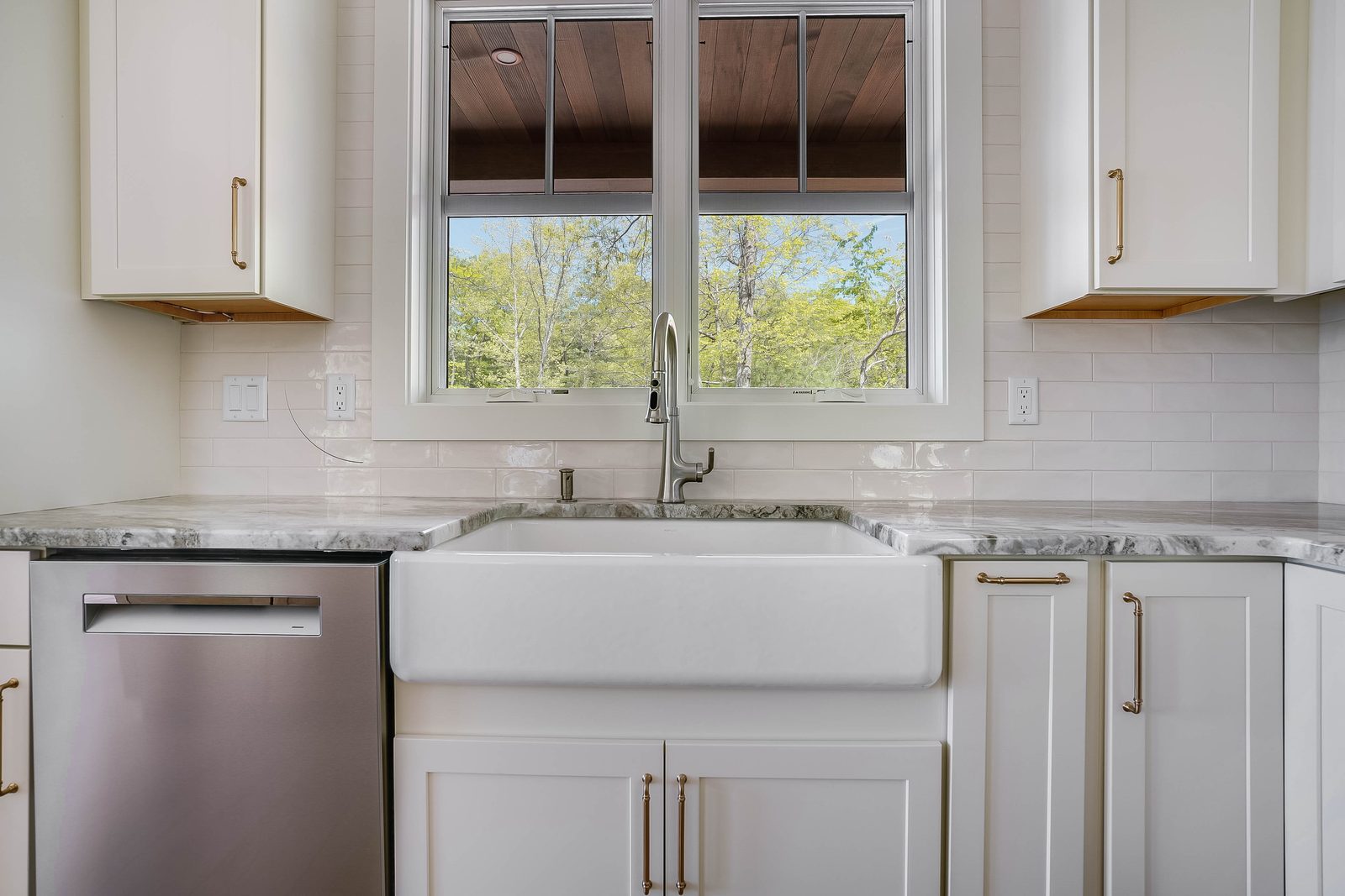 Farmhouse sink flanked by Coconut cabinetry
