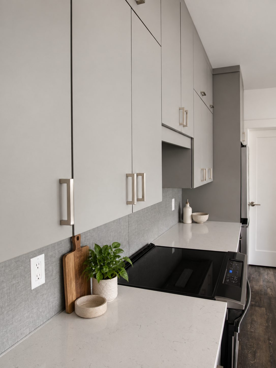 Tall gray pantry cabinets in a finished unit kitchen