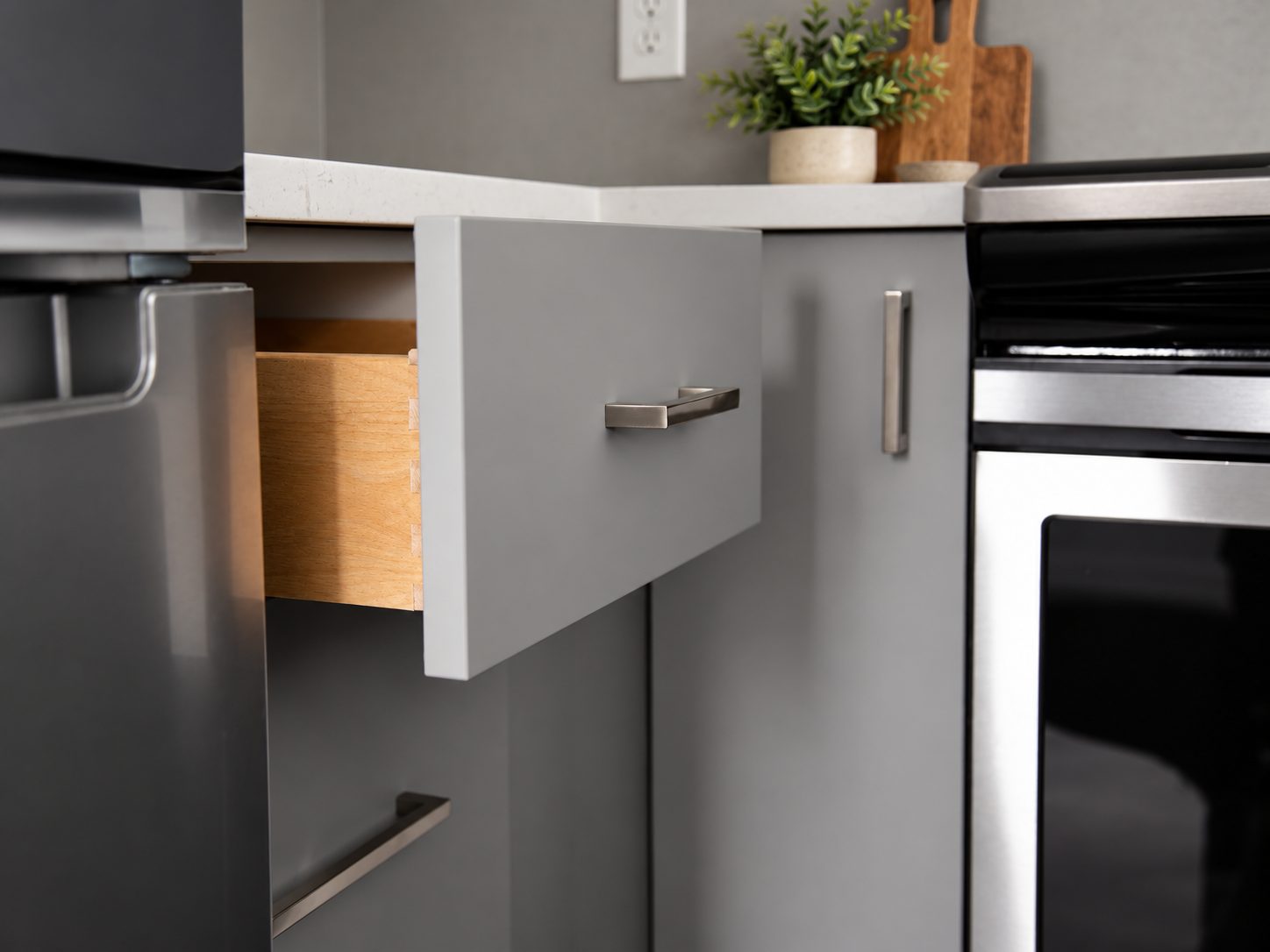 Dovetail drawer box open beside the wall oven