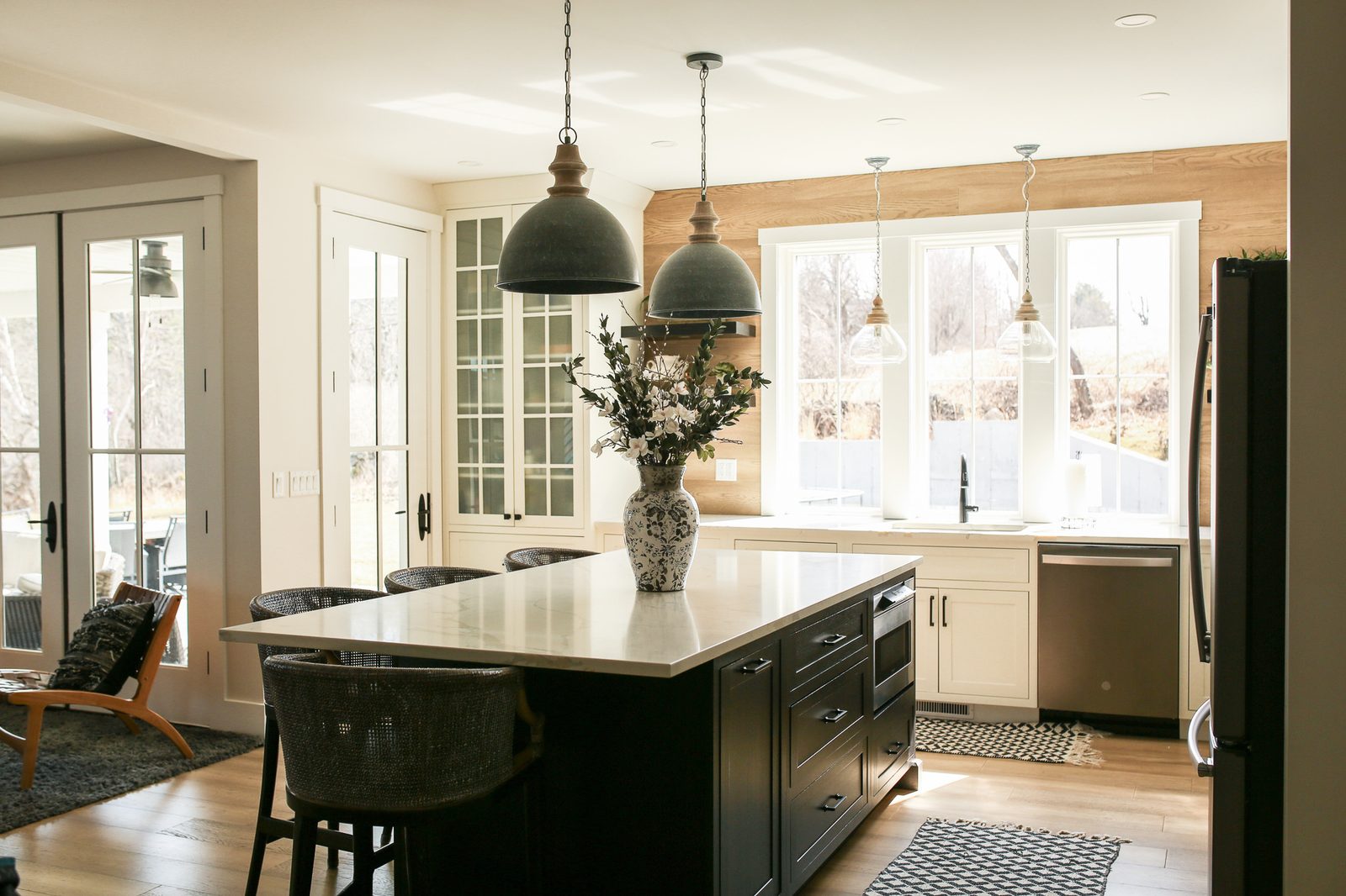 Kitchen seen from the living room, pendants over the island